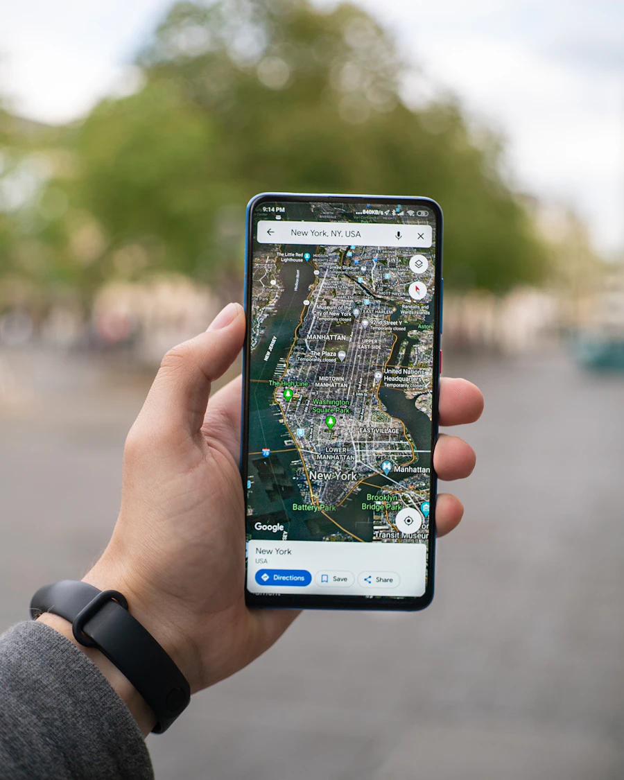 A hand holding a phone with a map app open
